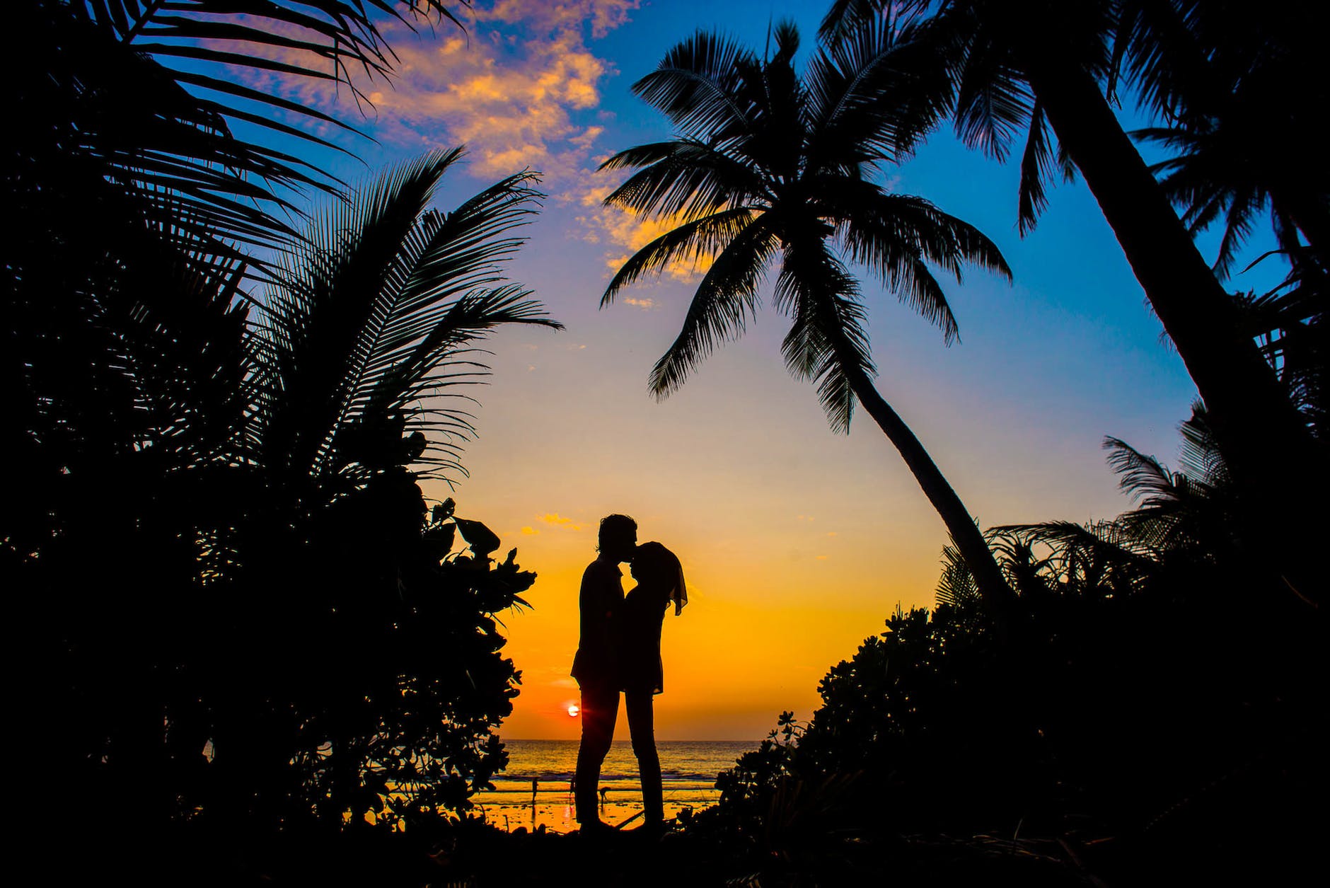 silhouette of man and woman kissing