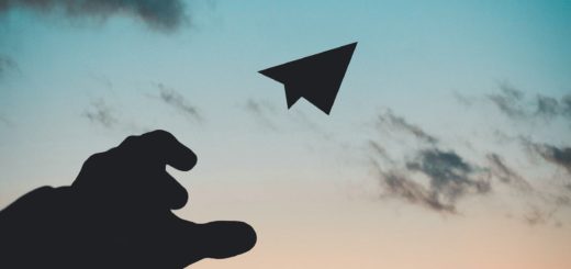 silhouette photo of man throw paper plane