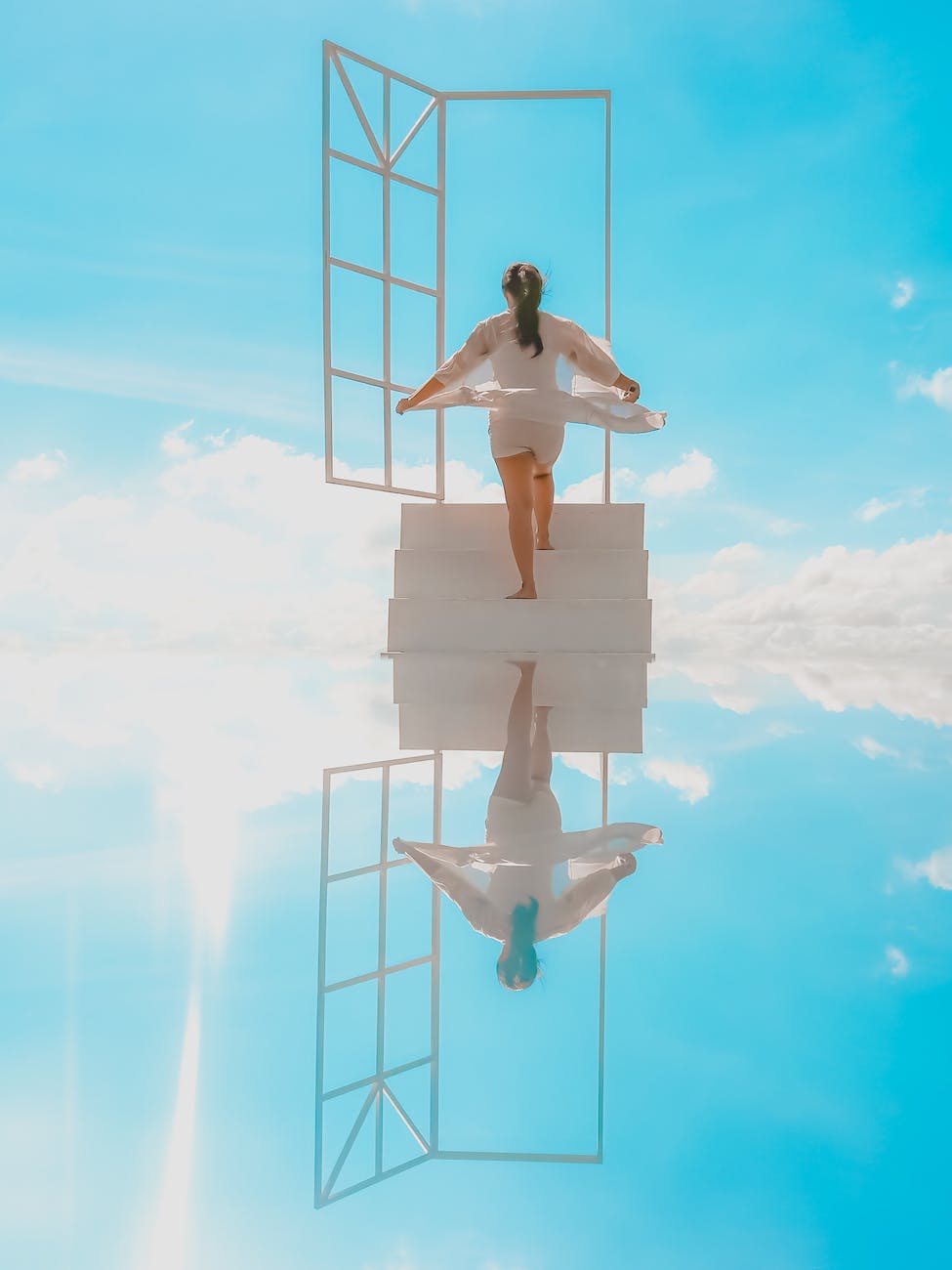 woman walking stairs to open doors in heaven