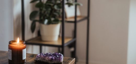 amethyst near burning candle in room