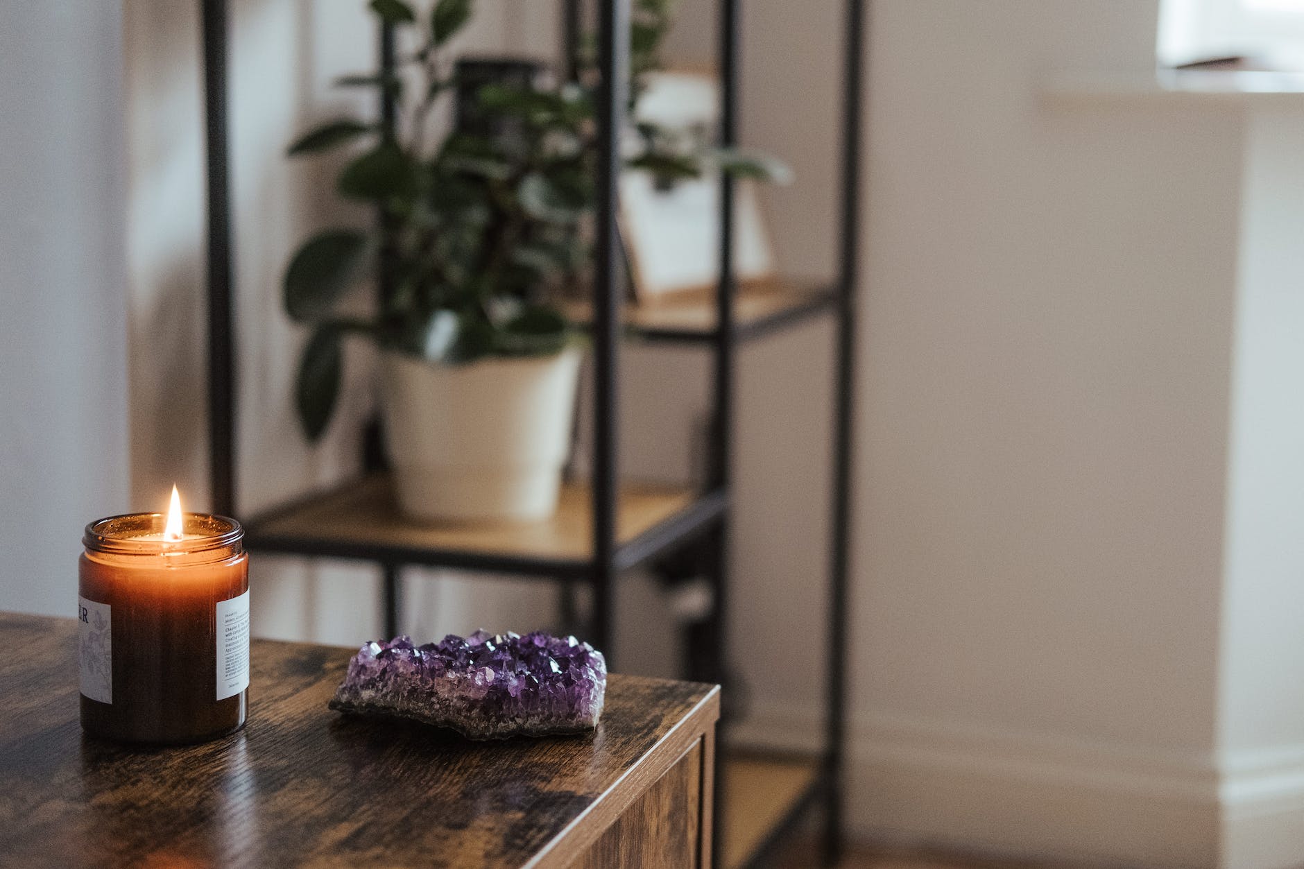 amethyst near burning candle in room