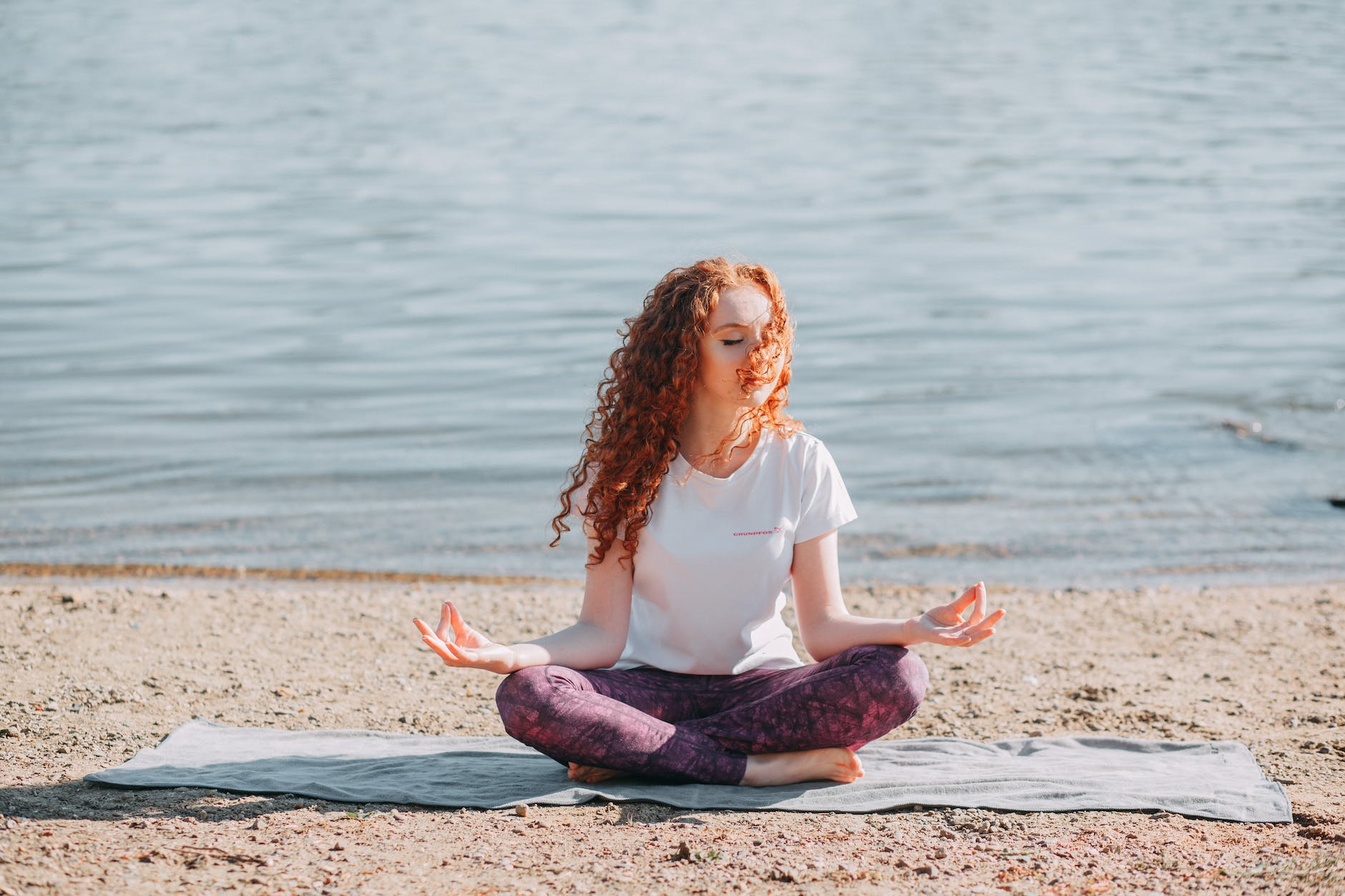 woman doing yoga and meditation in front of the sea