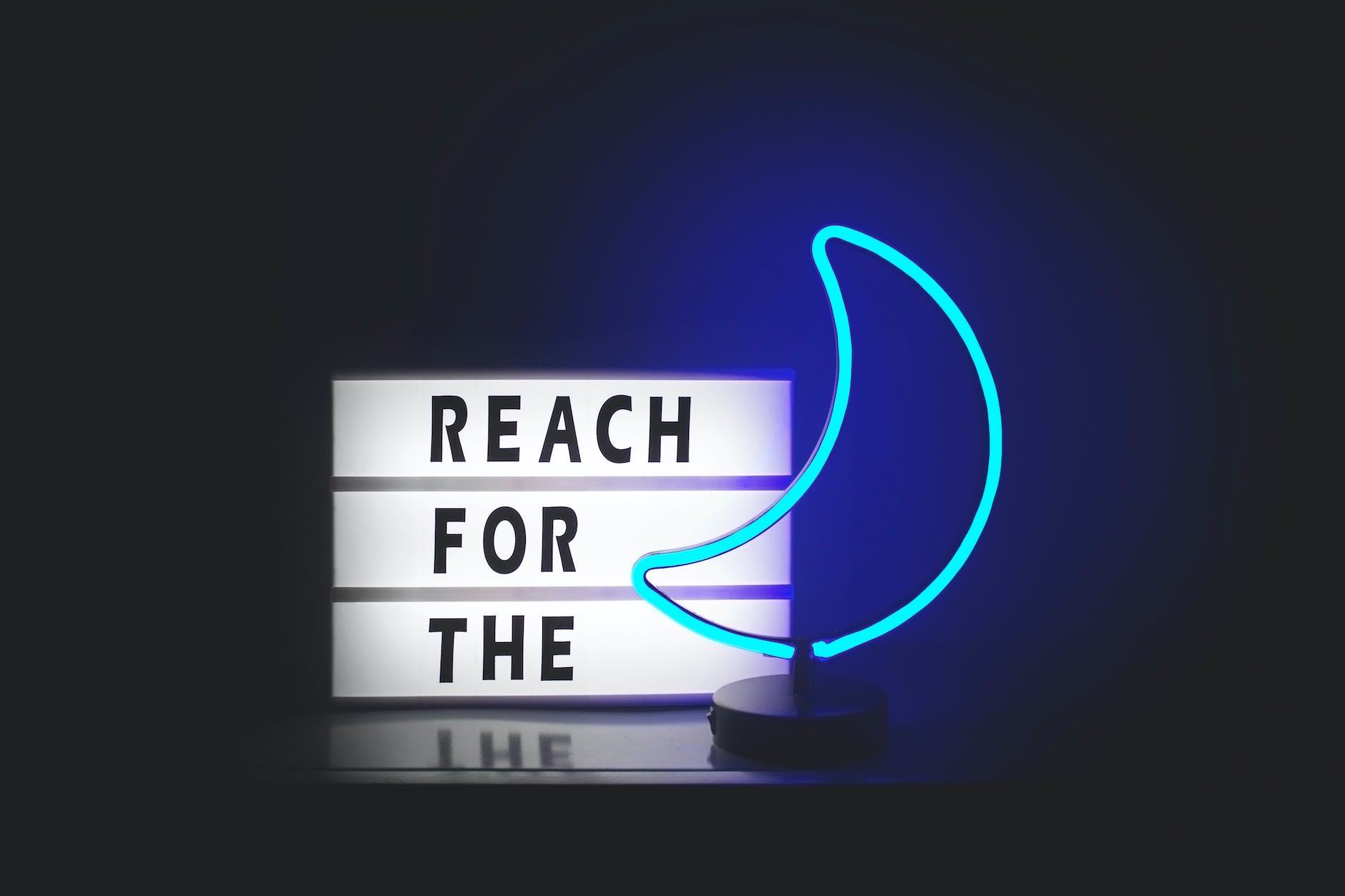 reach for the and blue moon neon signages