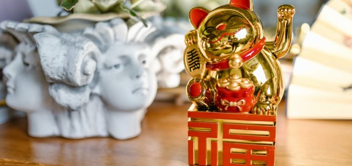 golden lucky cat over a wooden table