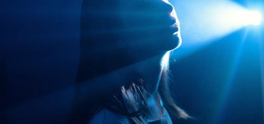 sensitive woman in shiny blue light ray