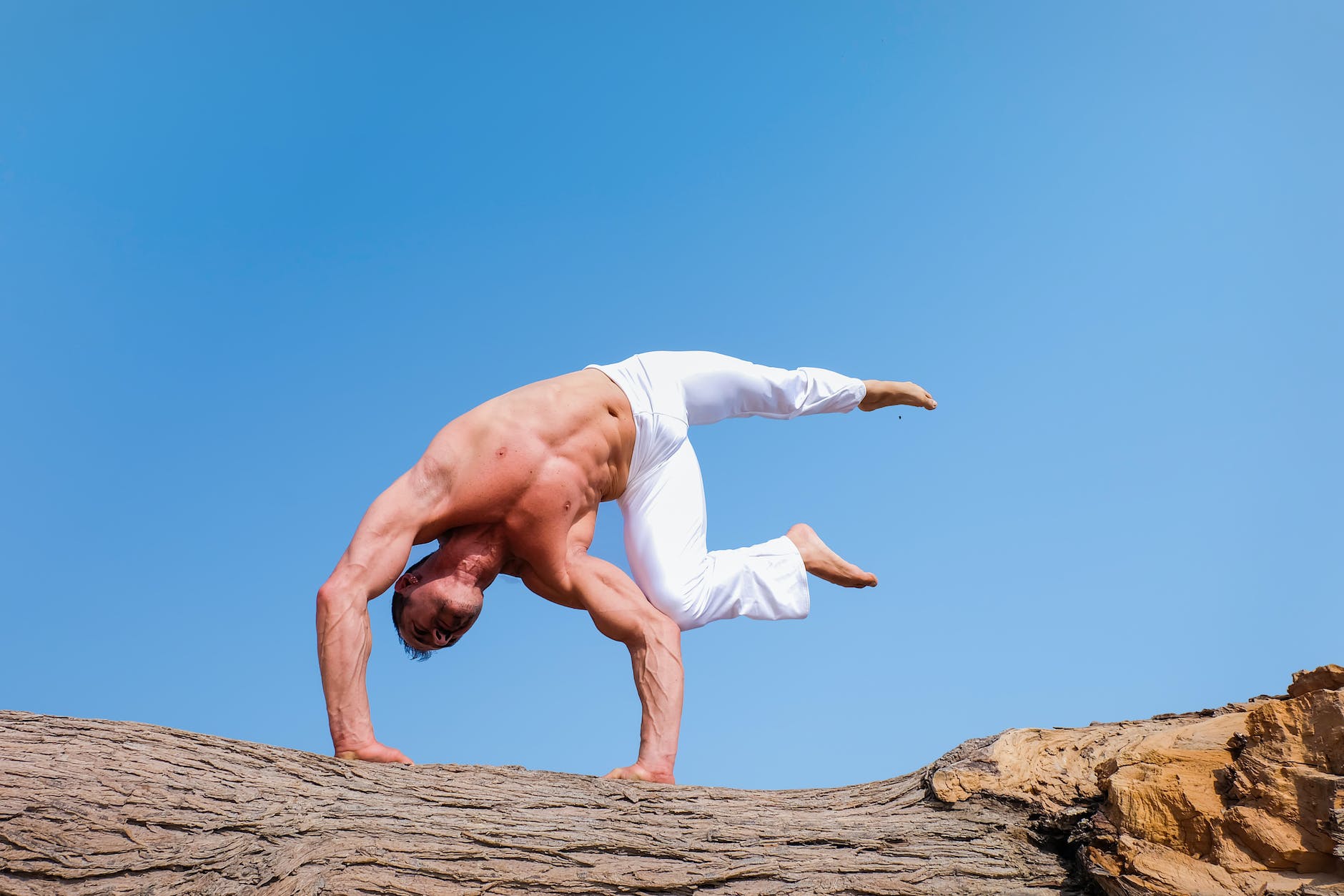 man wearing white pants under blue sky