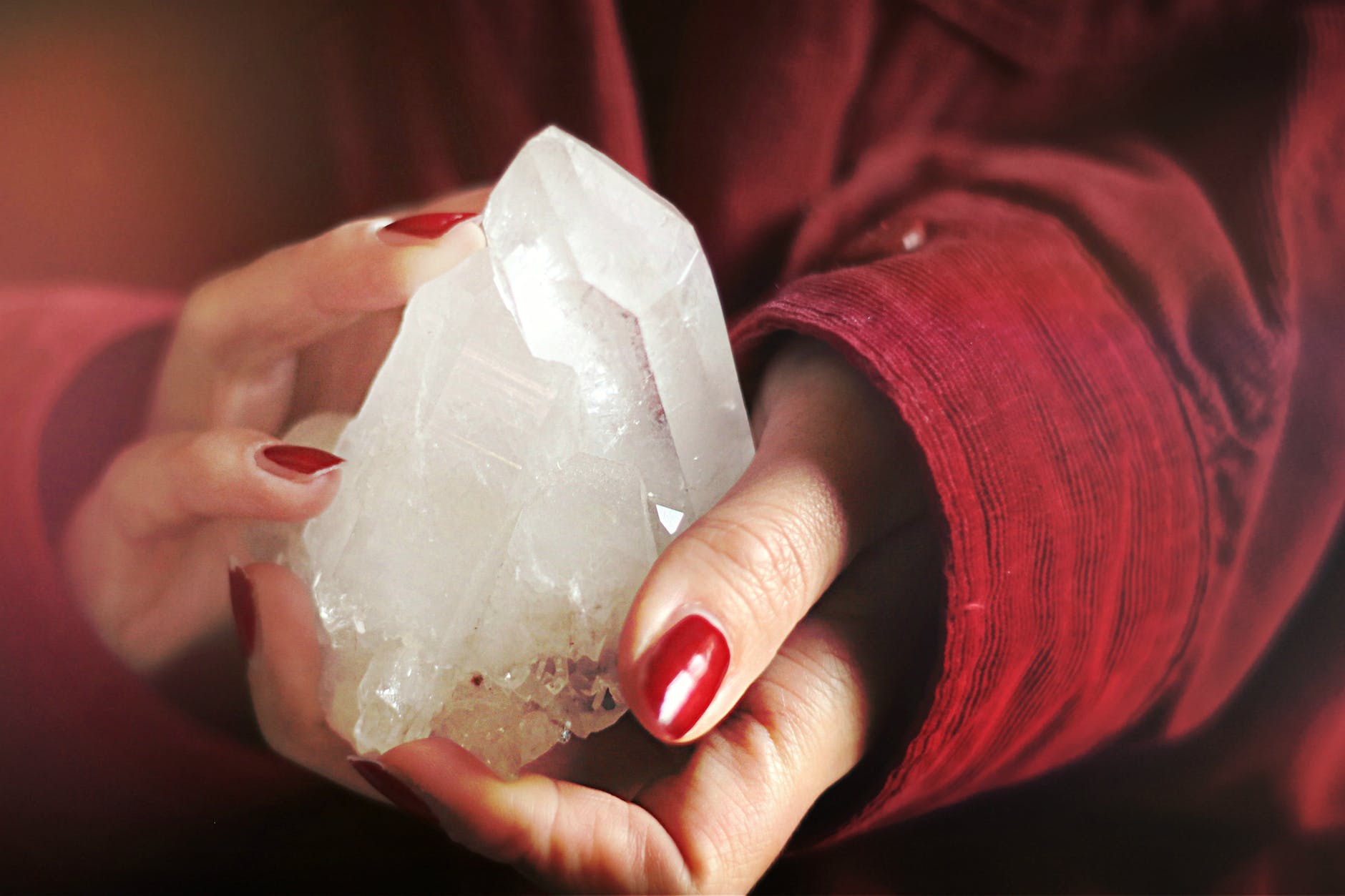 close up photo of person holding crystal stone