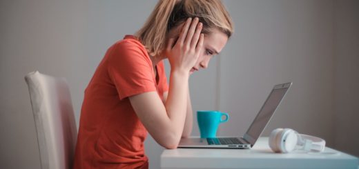 young troubled woman using laptop at home