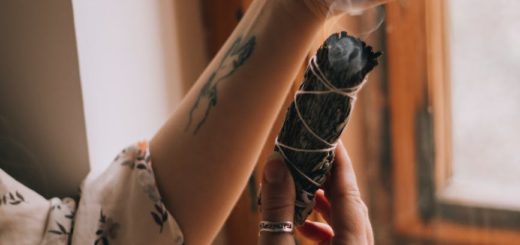 hands of woman burning palo santo wood