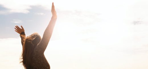 photo of woman raising both hands