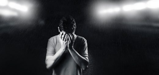 monochrome photo of man covering his face