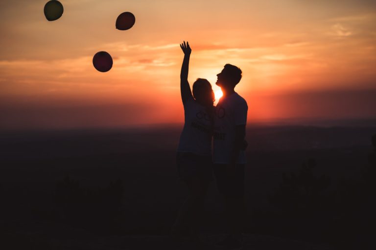 silhouette photo of couple standing outdoors