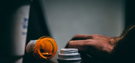 orange and white prescription bottle on table