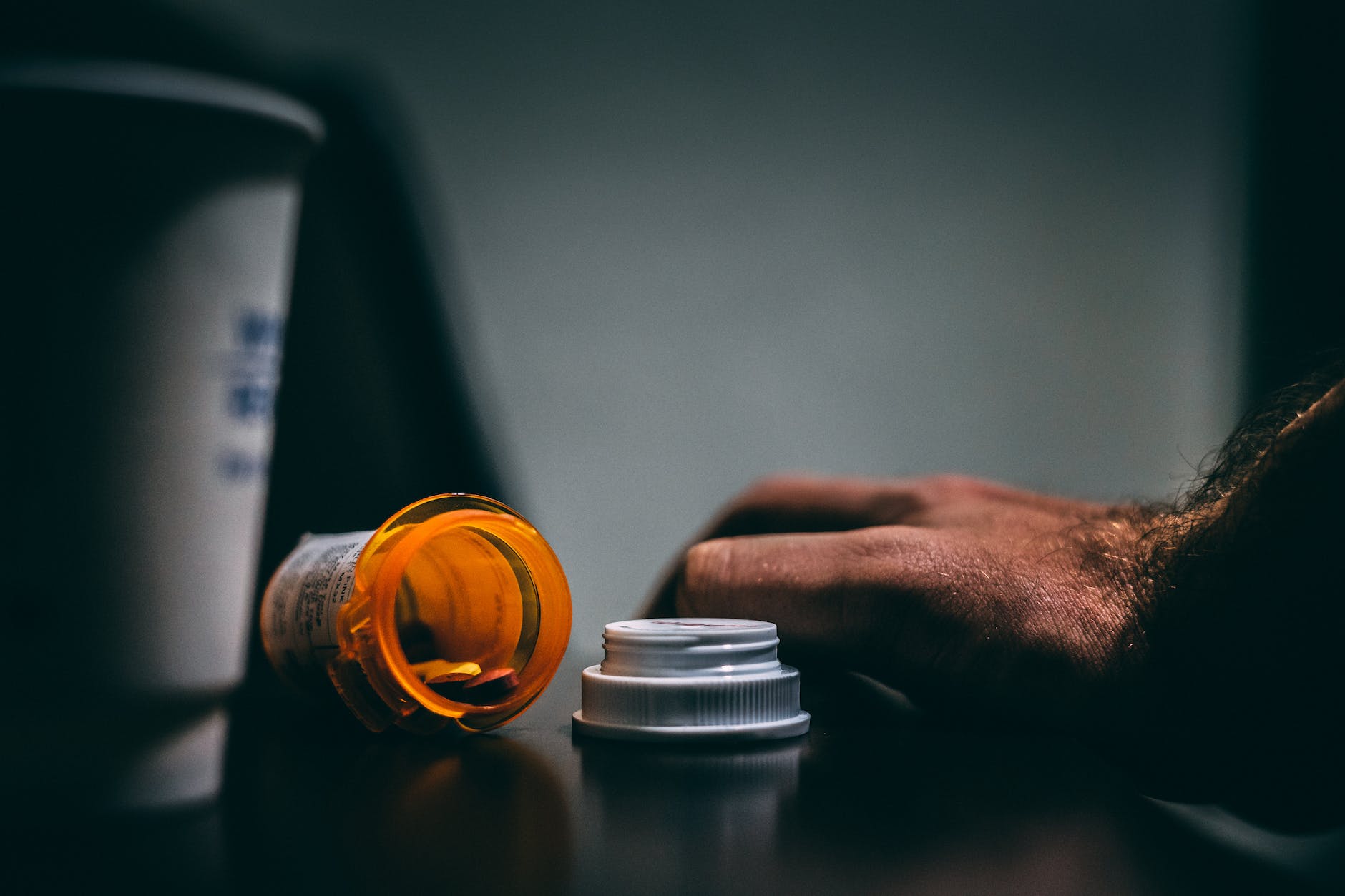 orange and white prescription bottle on table