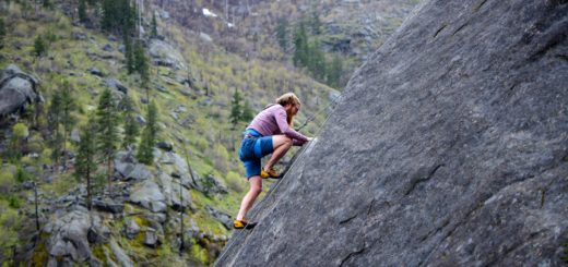 man climbing on rock mountain