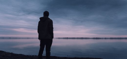 person standing near lake