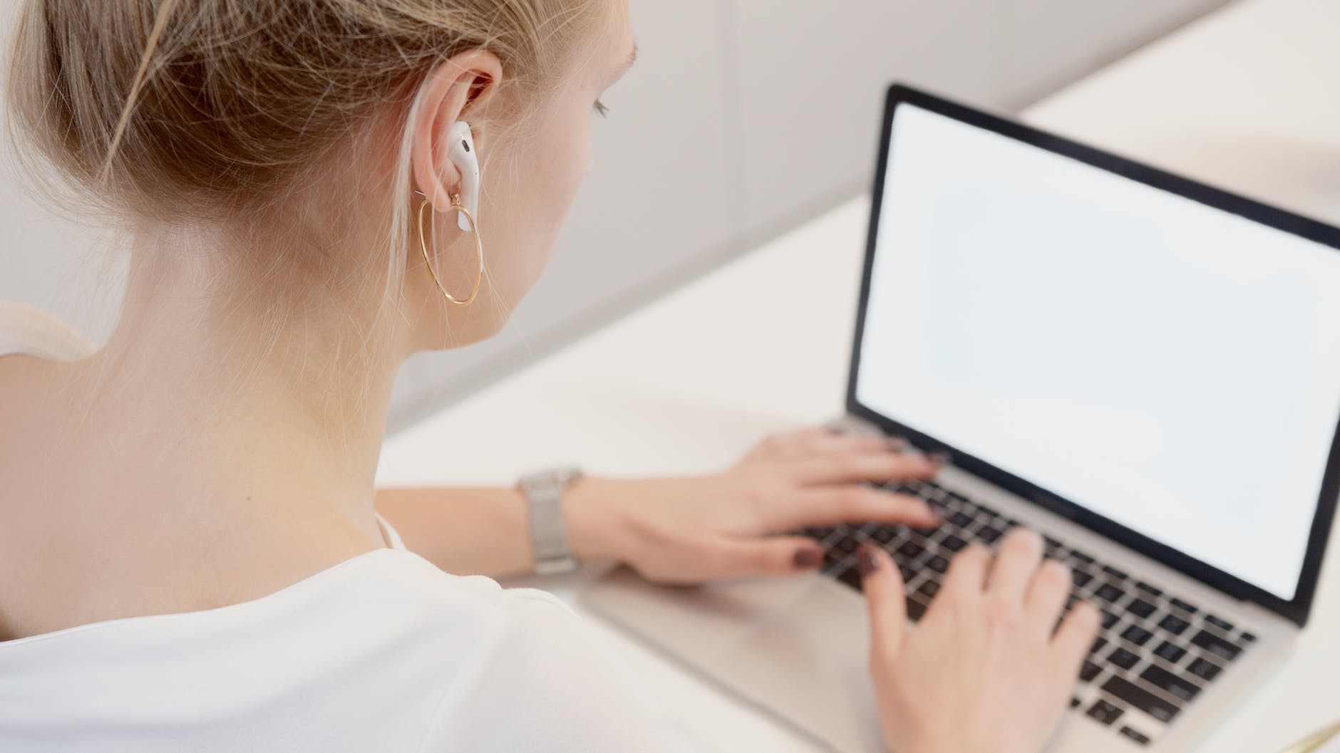 a woman typing on a laptop