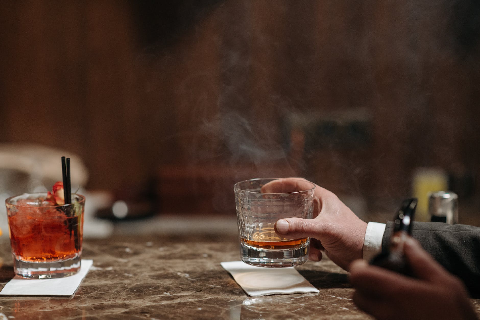 person holding a glass of liquor