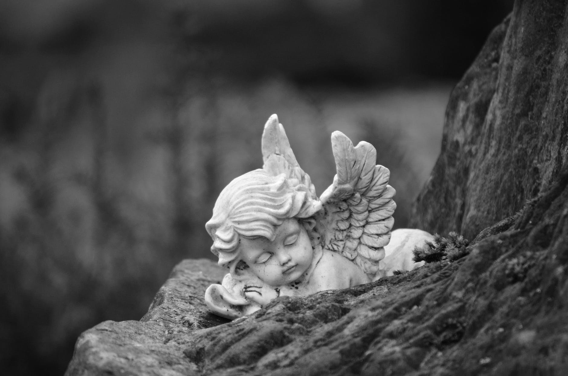 black and white photo of an angel figurine