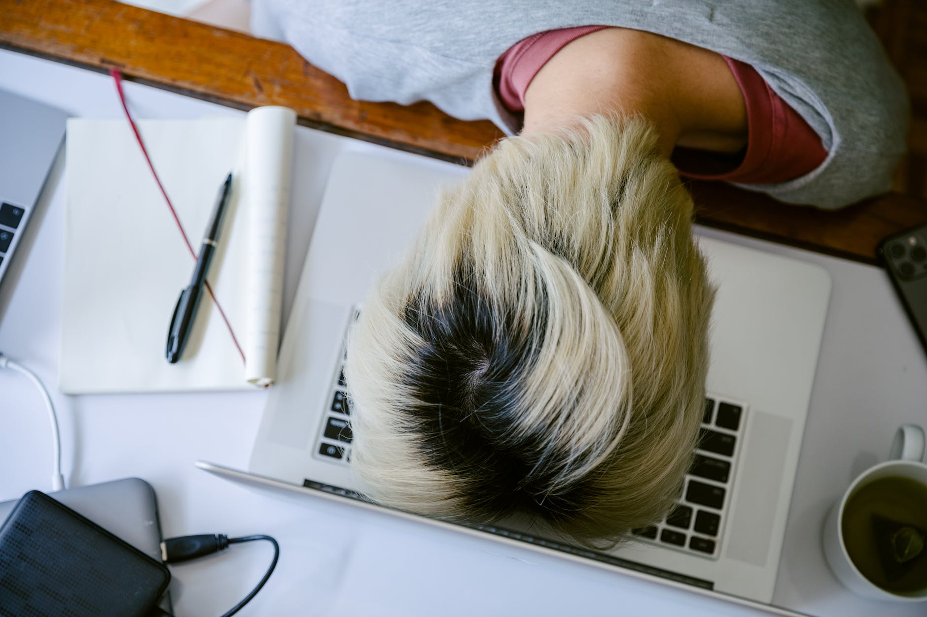 exhausted woman with head on keyboard