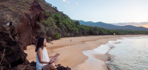 young ethnic woman meditate on empty beach