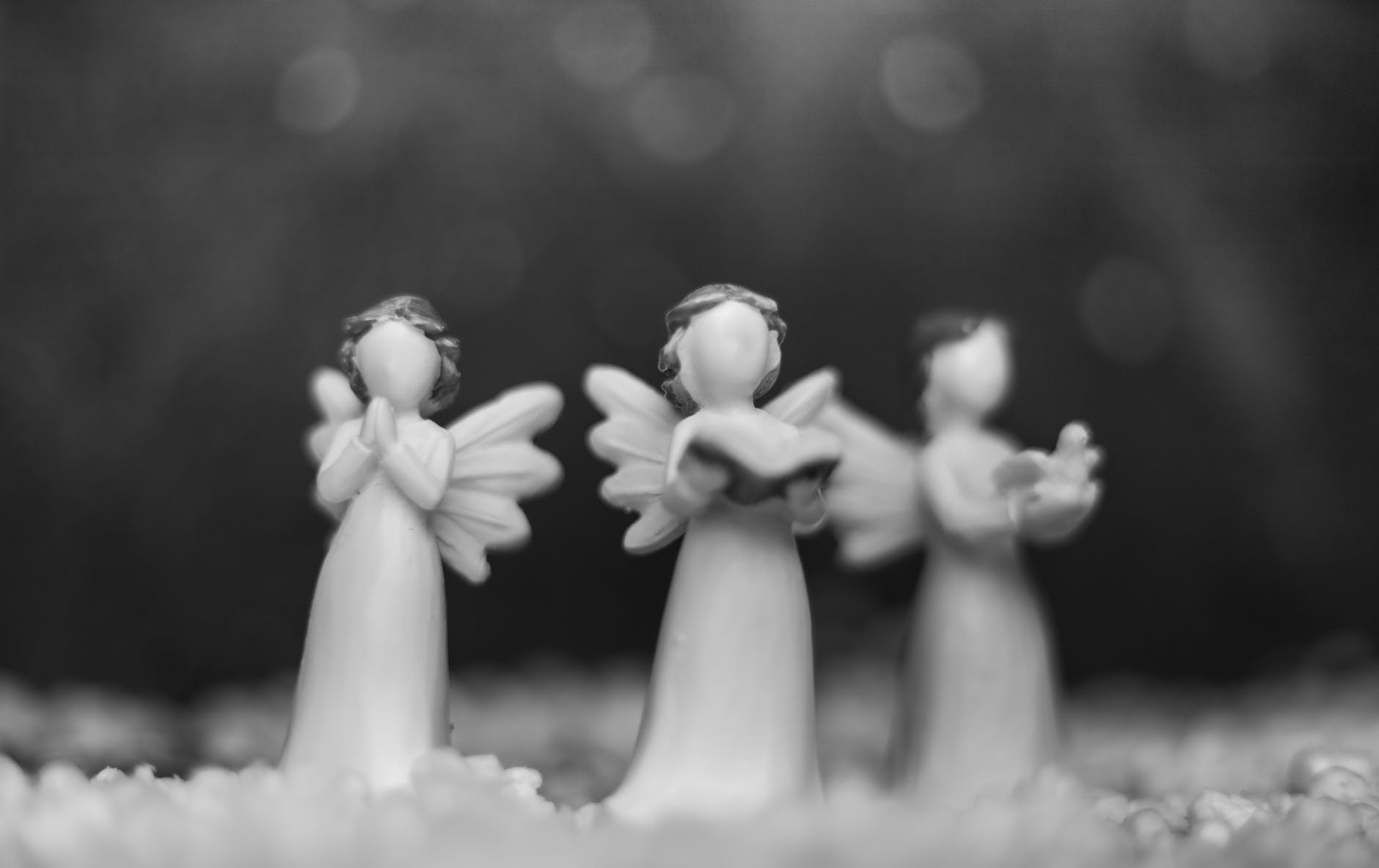 grayscale photo of angel figurines