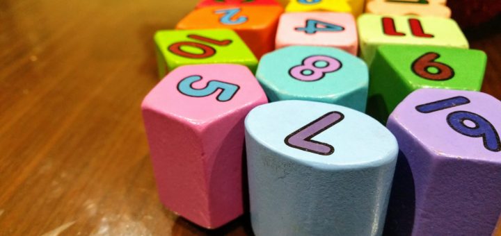 assorted color dice toy on wooden table