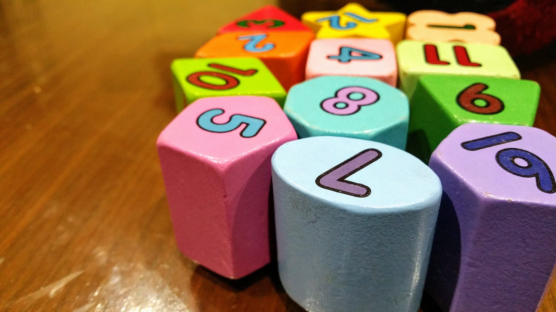 assorted color dice toy on wooden table