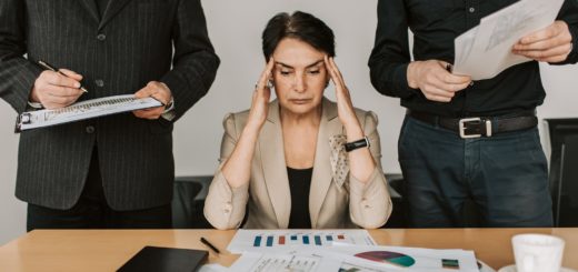 stressed elderly woman holding her head