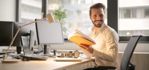 photo of man holding a book