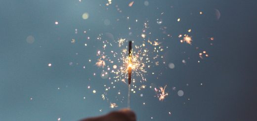 person holding lighted sparklers