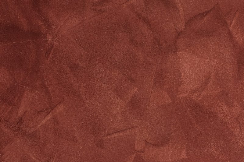 a red background with a rough texture of paper