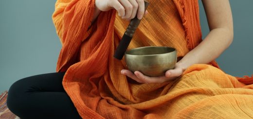 person in orange scarf holding silver round bowl