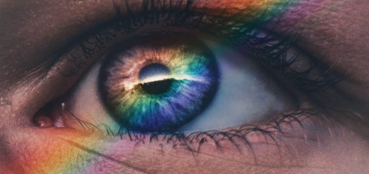 close up photography of rainbow rays on eye