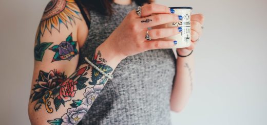 woman holding white ceramic mug