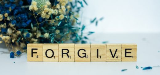 a wooden block that says for give next to a bouquet of flowers