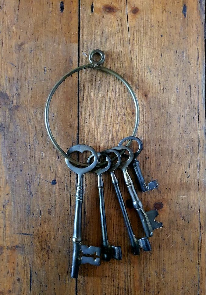 silver skeleton keys on brown wooden table